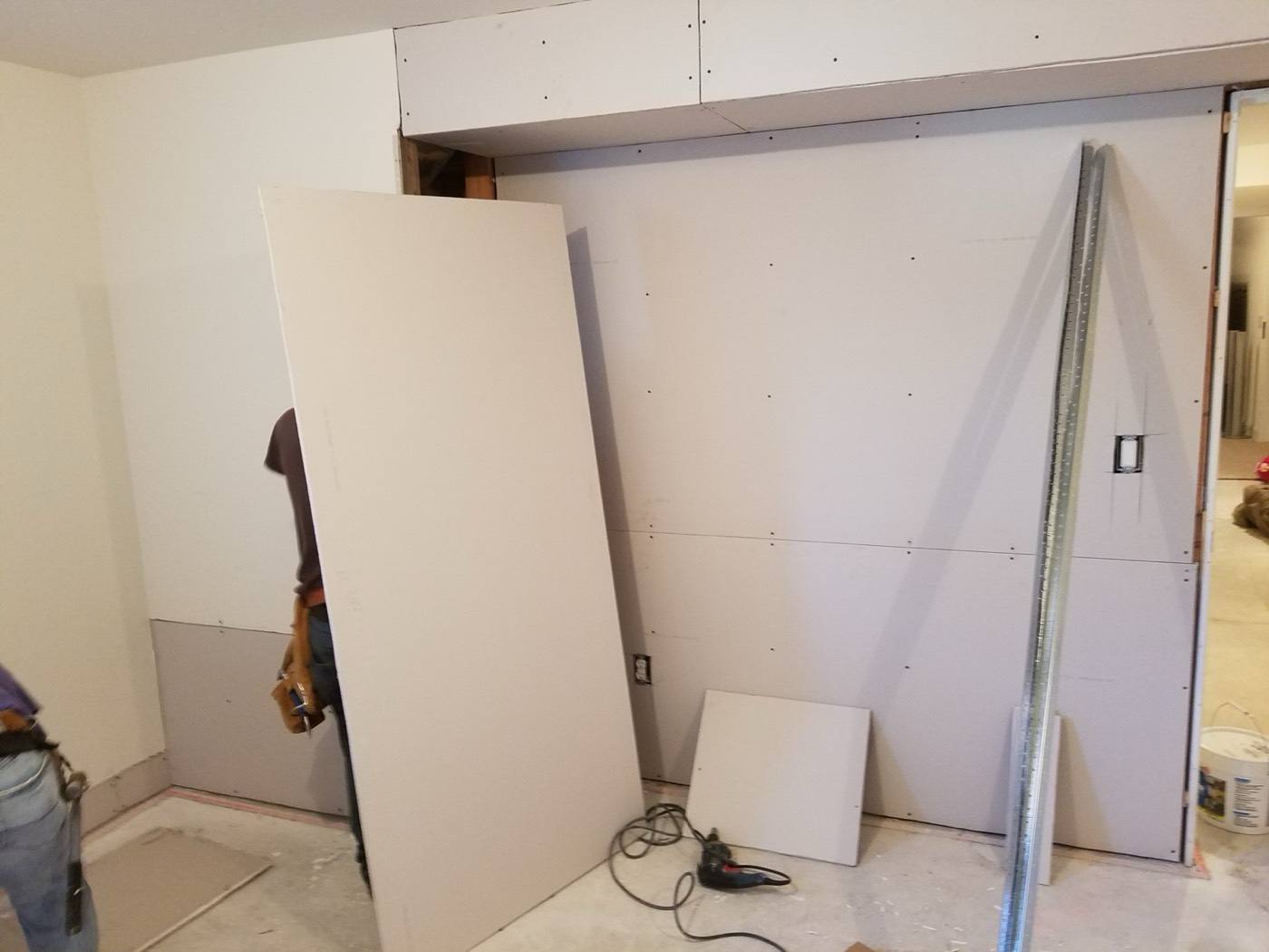 Drywall going up in a basement room