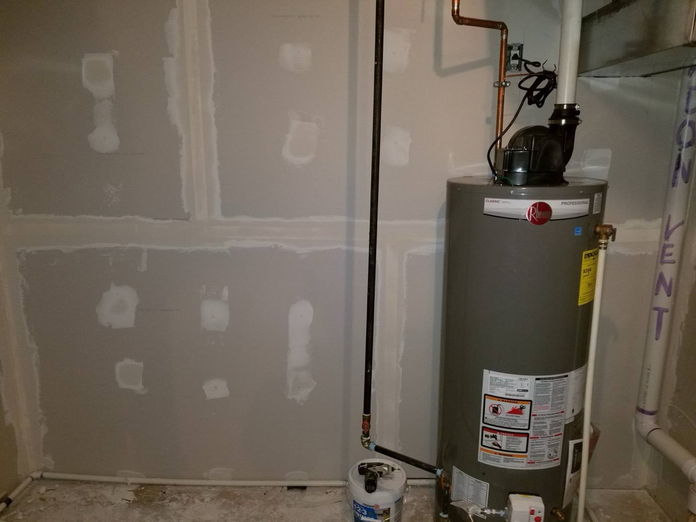 Basement utility room with taped drywall