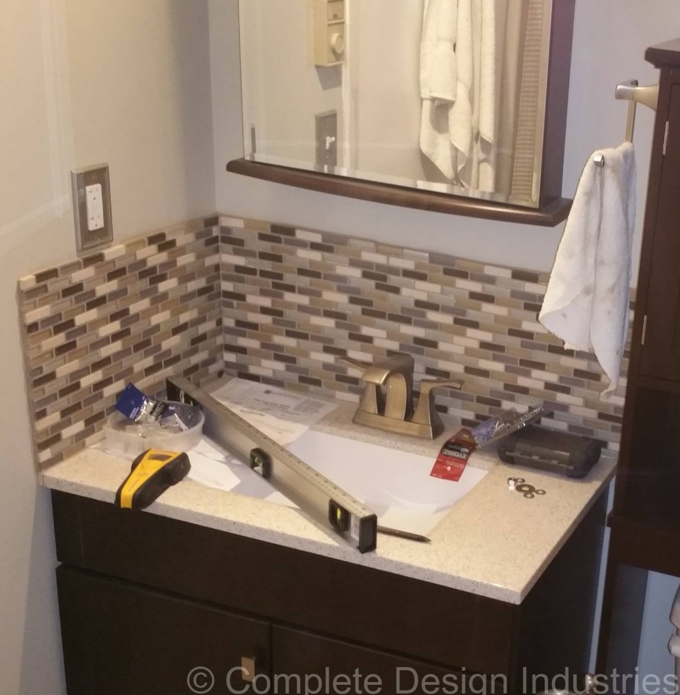 Mosaic tile backsplash going in behind a vanity