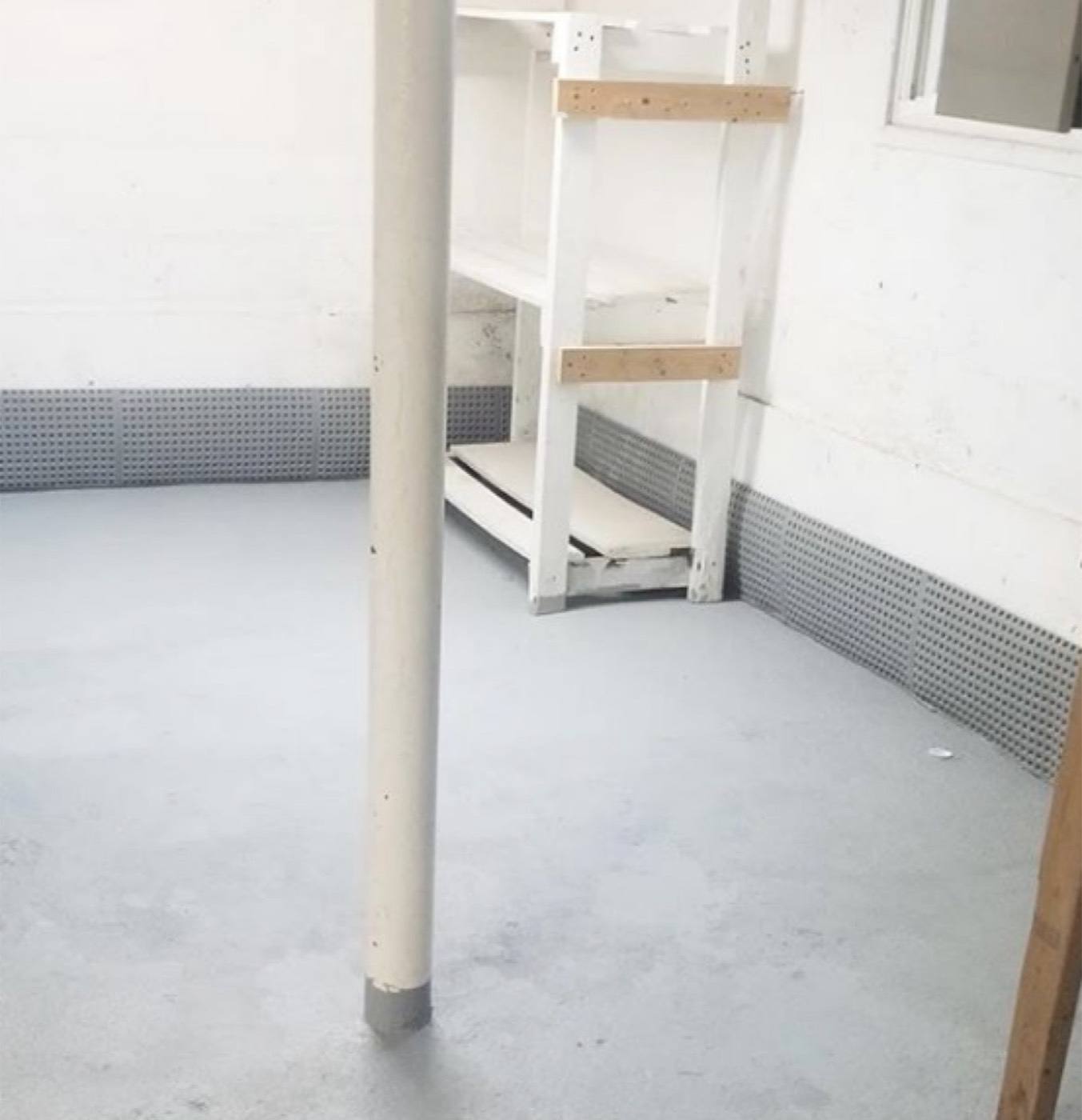 Finished French drain with patched, painted floor