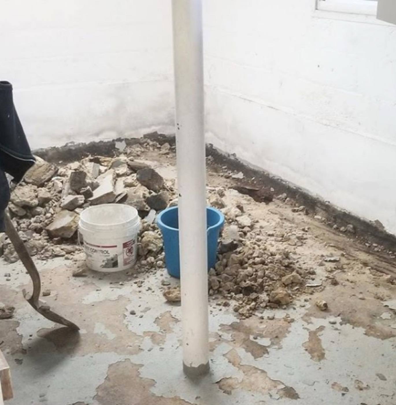 Basement floor broken out along the wall for a perimeter drain