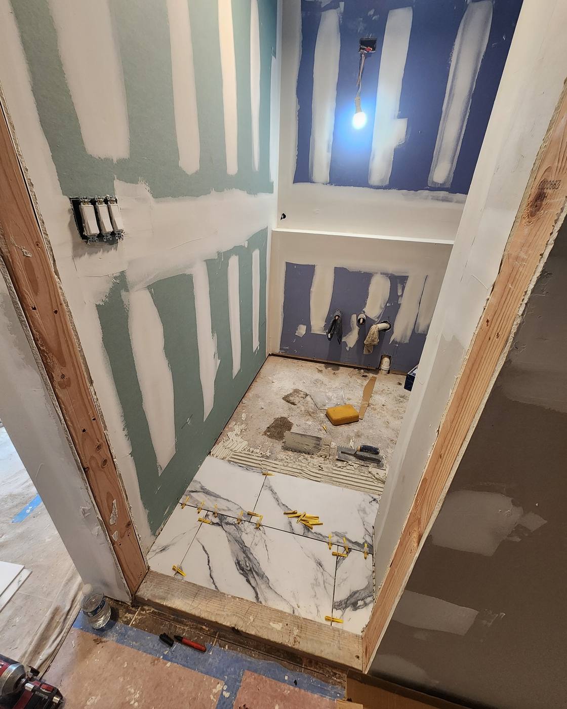 Floor tile being set over prepared subfloor