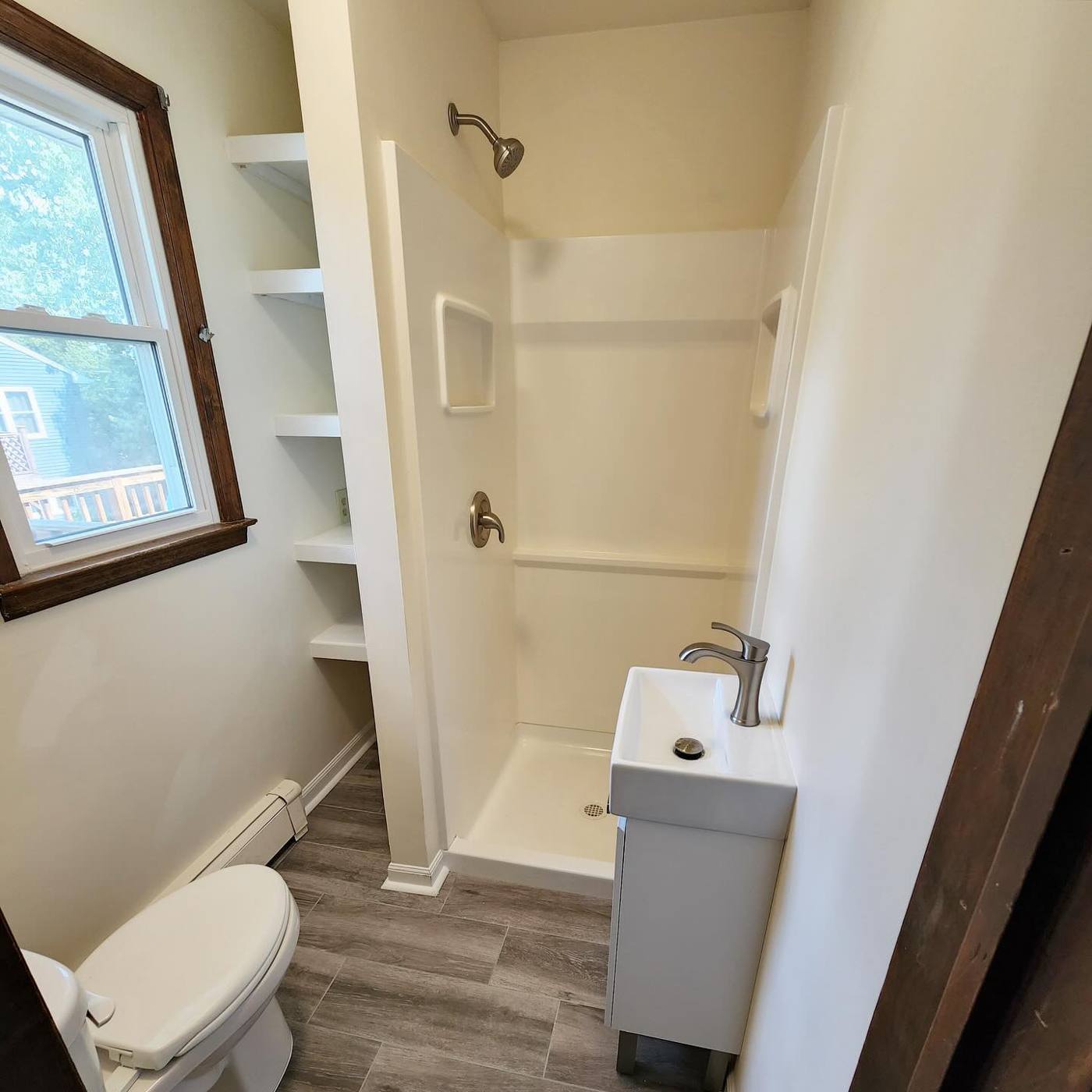 Same bathroom with new shower, shelves and vanity