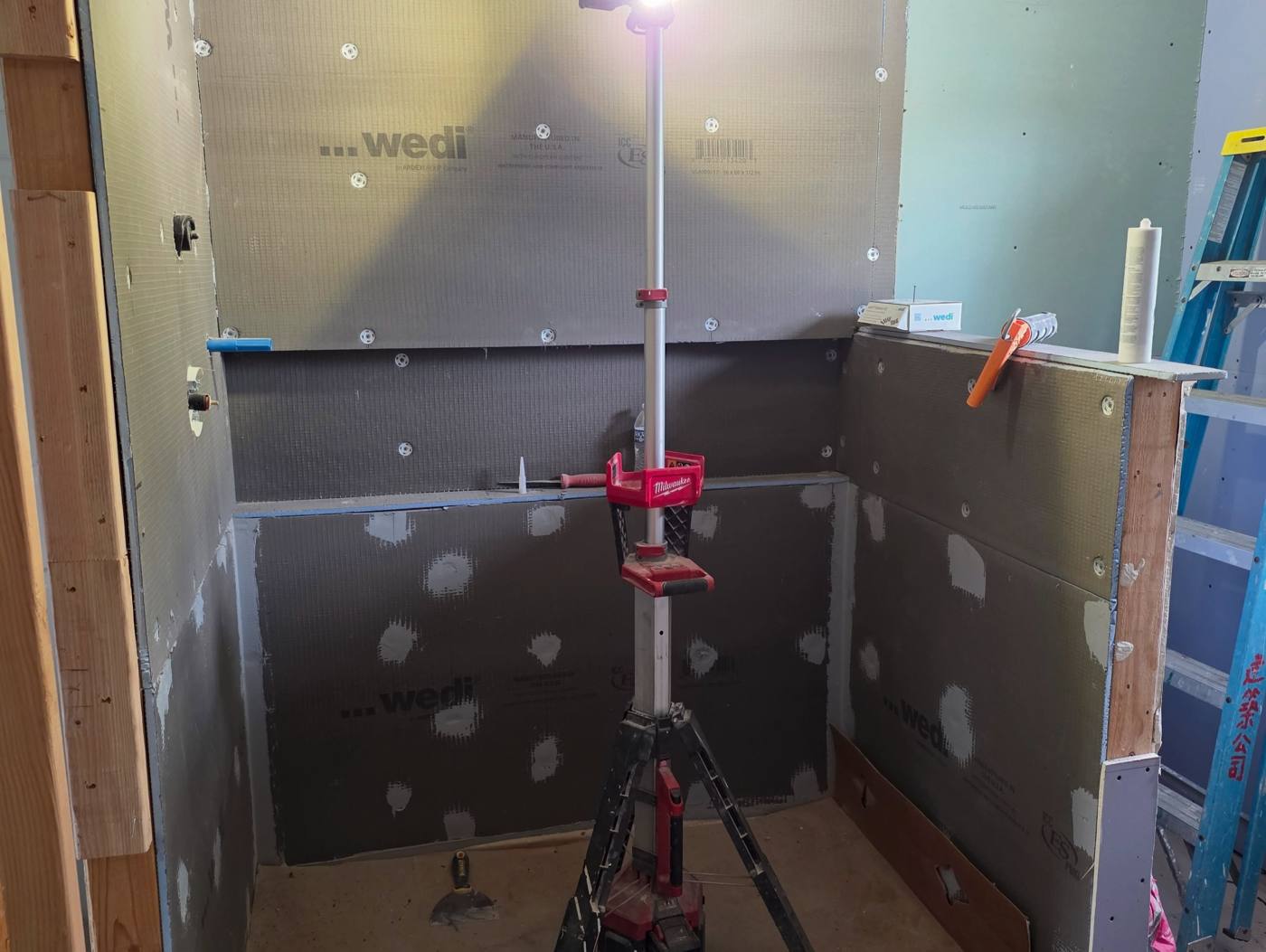 Shower walls sheathed in waterproof board, seams sealed