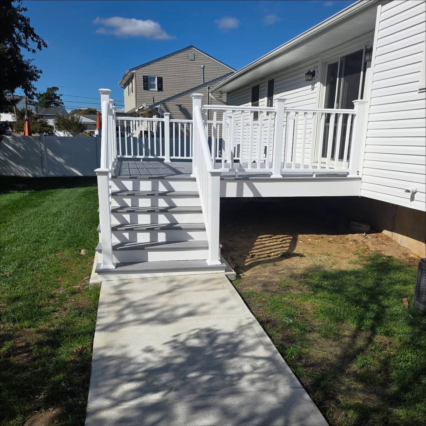 Composite deck with white railings, stairs and new walkway