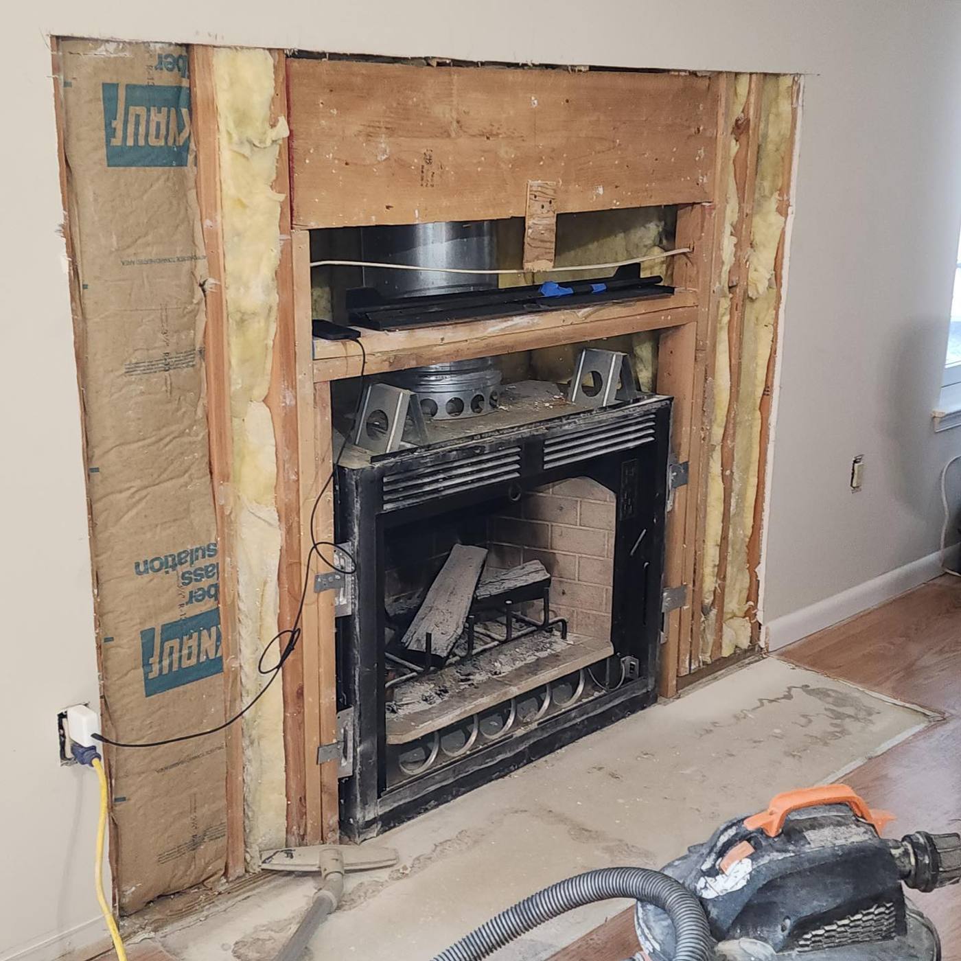 Fireplace opened up to framing and insulation