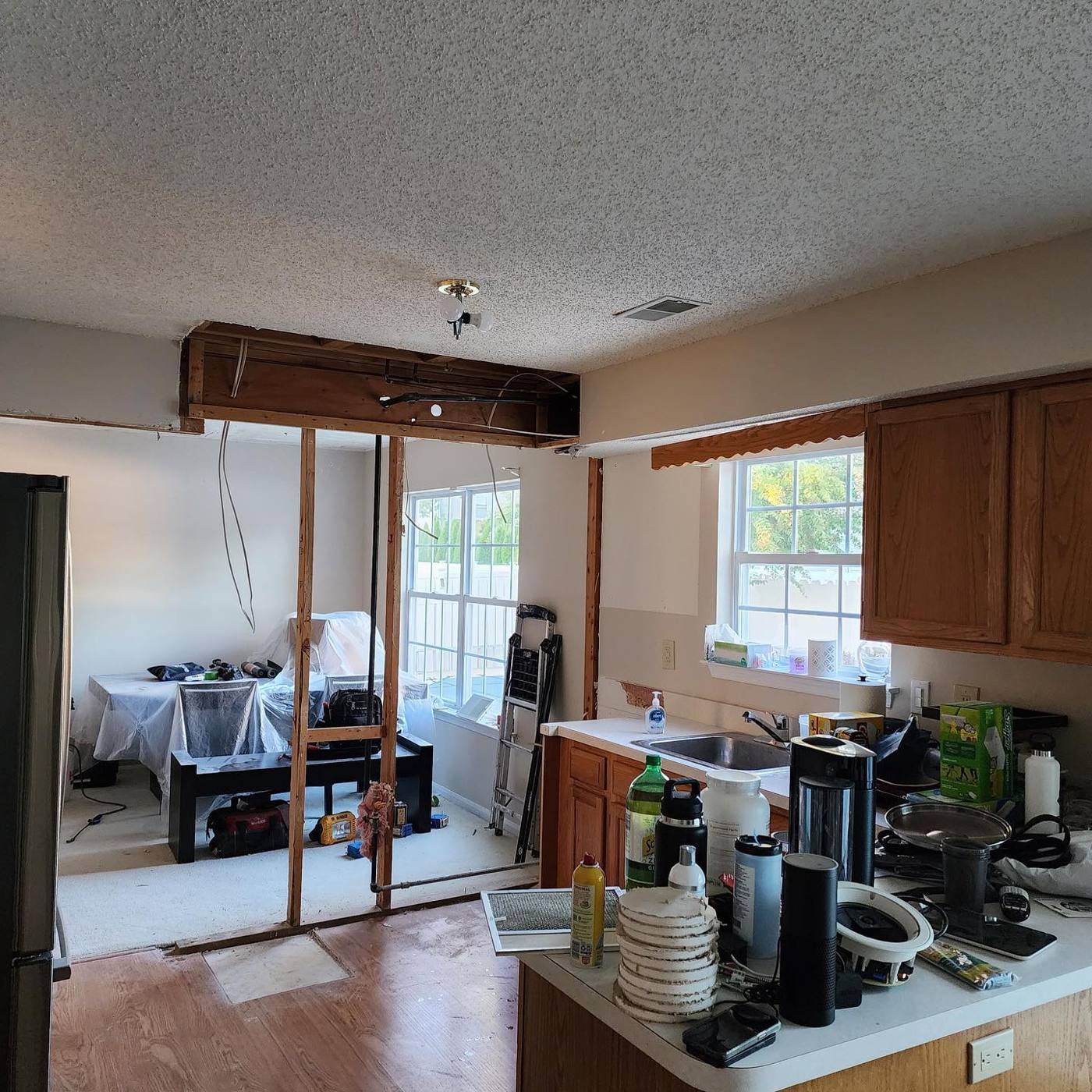 Closed-off kitchen with oak cabinets dividing it from the dining room