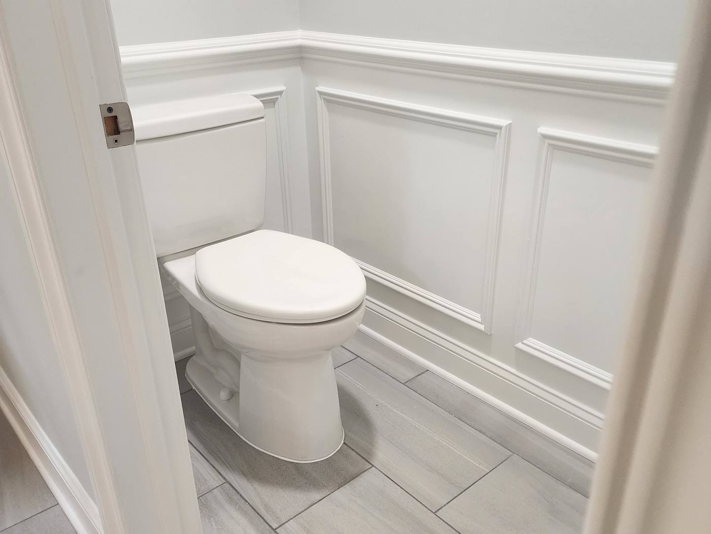 Finished powder room with white wainscoting