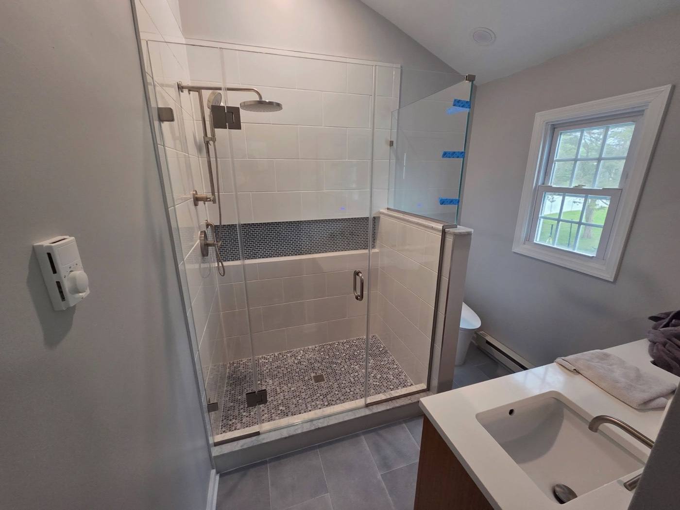 Frameless glass shower with pebble floor