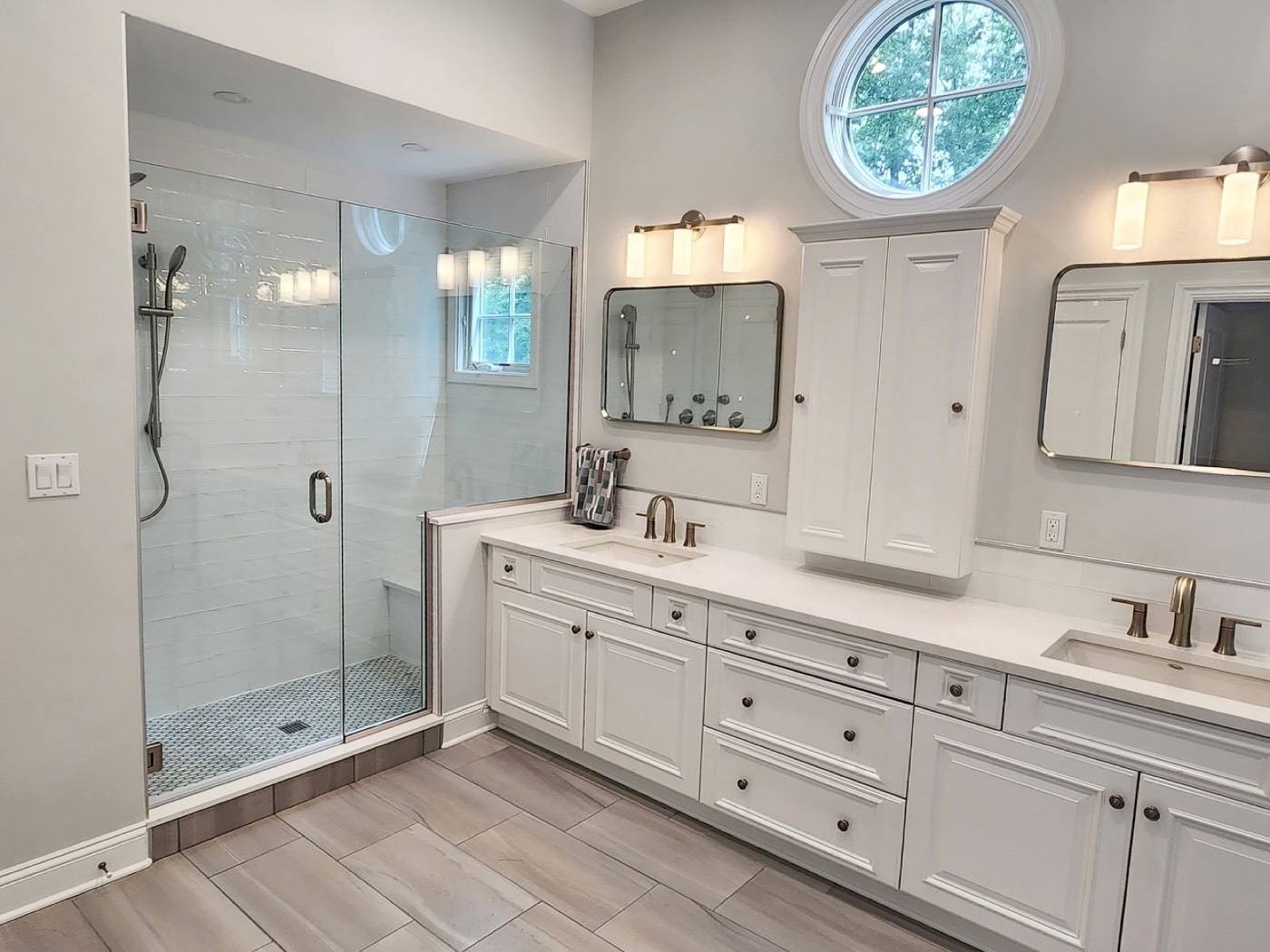 Primary bathroom with frameless glass shower and double vanity