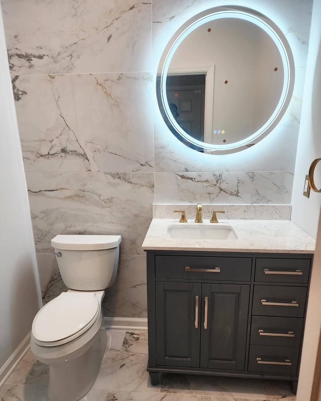Bathroom with marble-look wall tile and green vanity