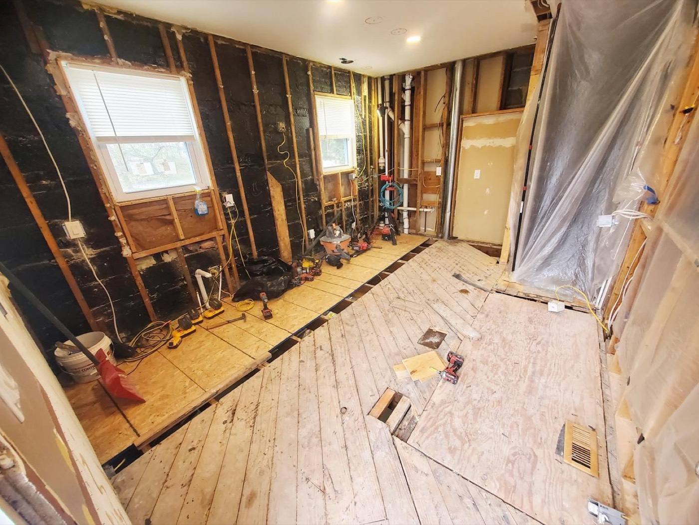 Kitchen mid-renovation with framing and new layout