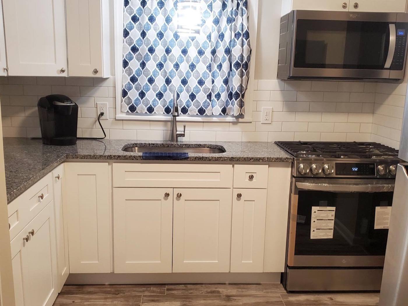 White kitchen with granite and subway tile