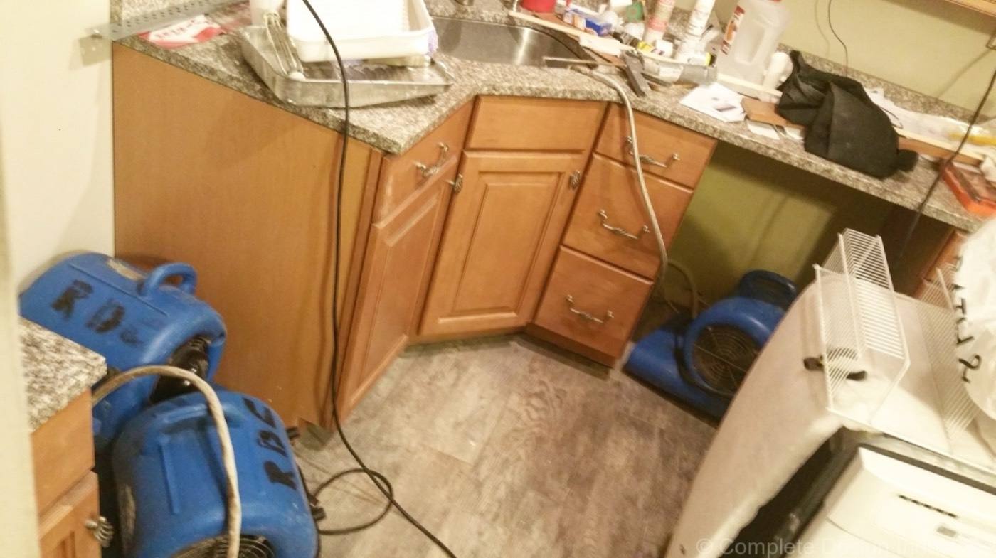 Kitchen being dried after water damage