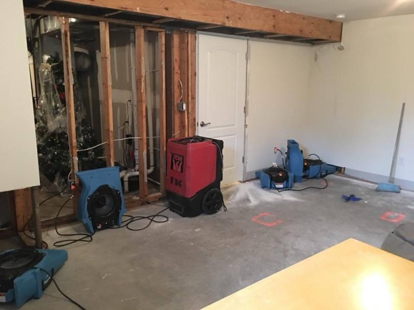 Restoration services NJ job: basement with walls opened and drying equipment running